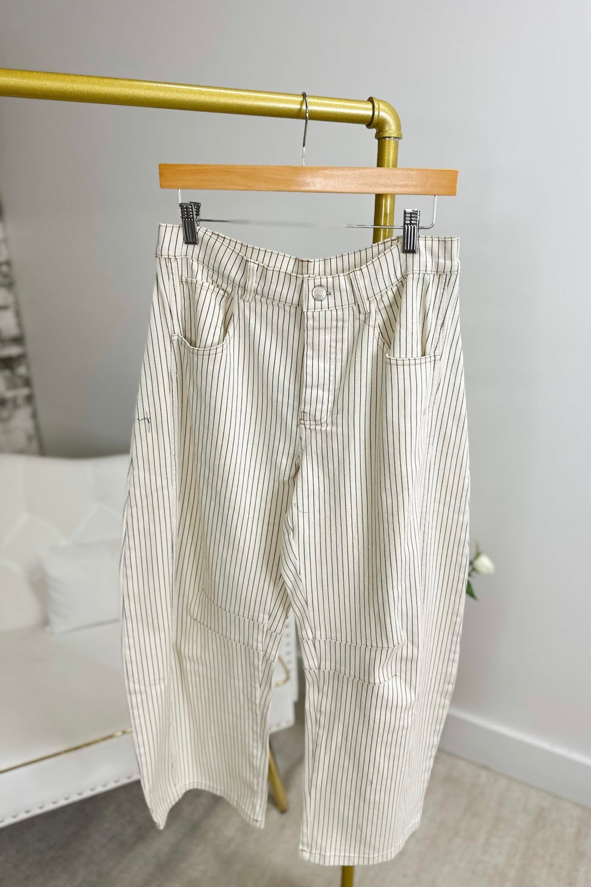 Off white striped pants with a curved barrel leg