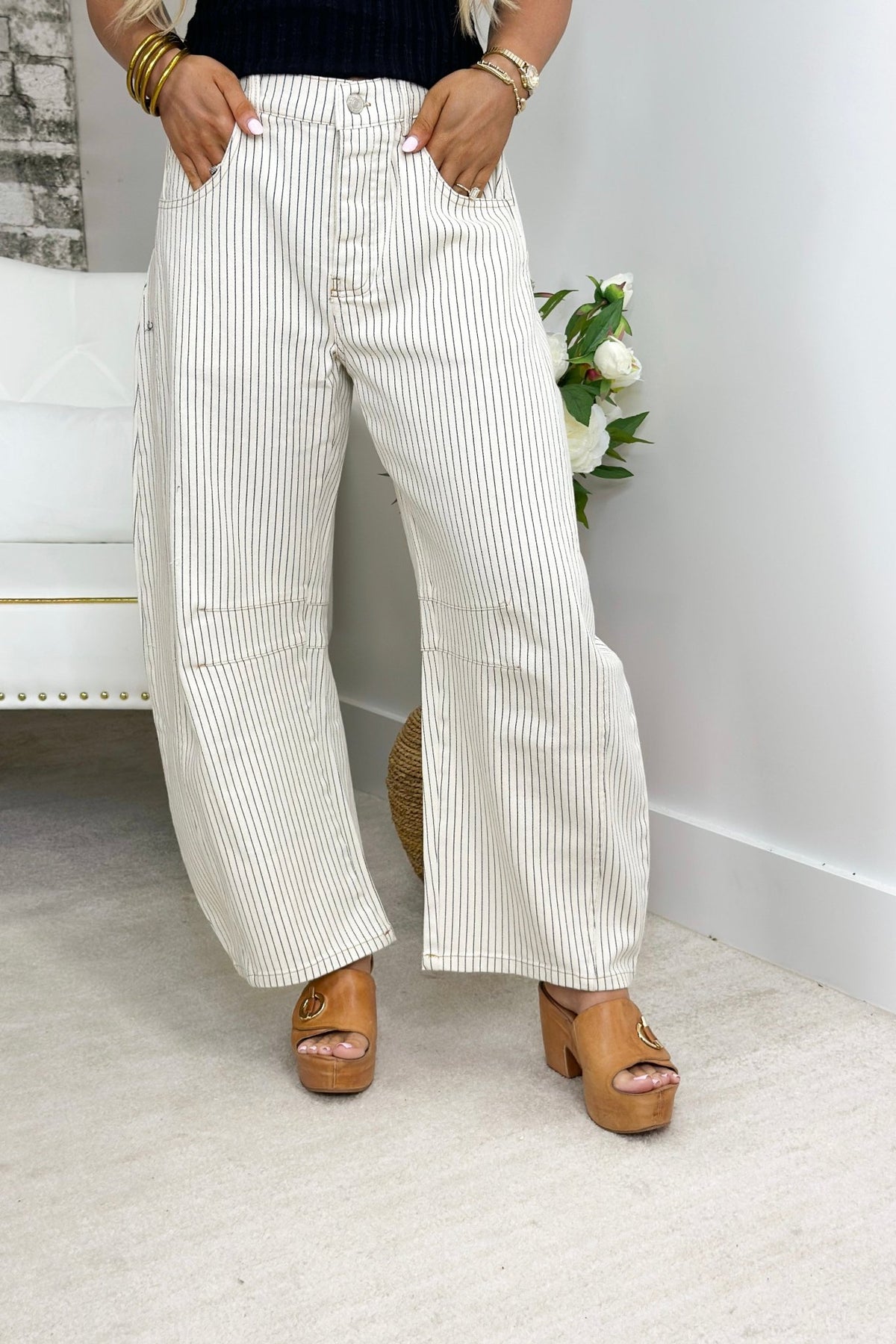 Off white striped pants with a barrel leg shape
