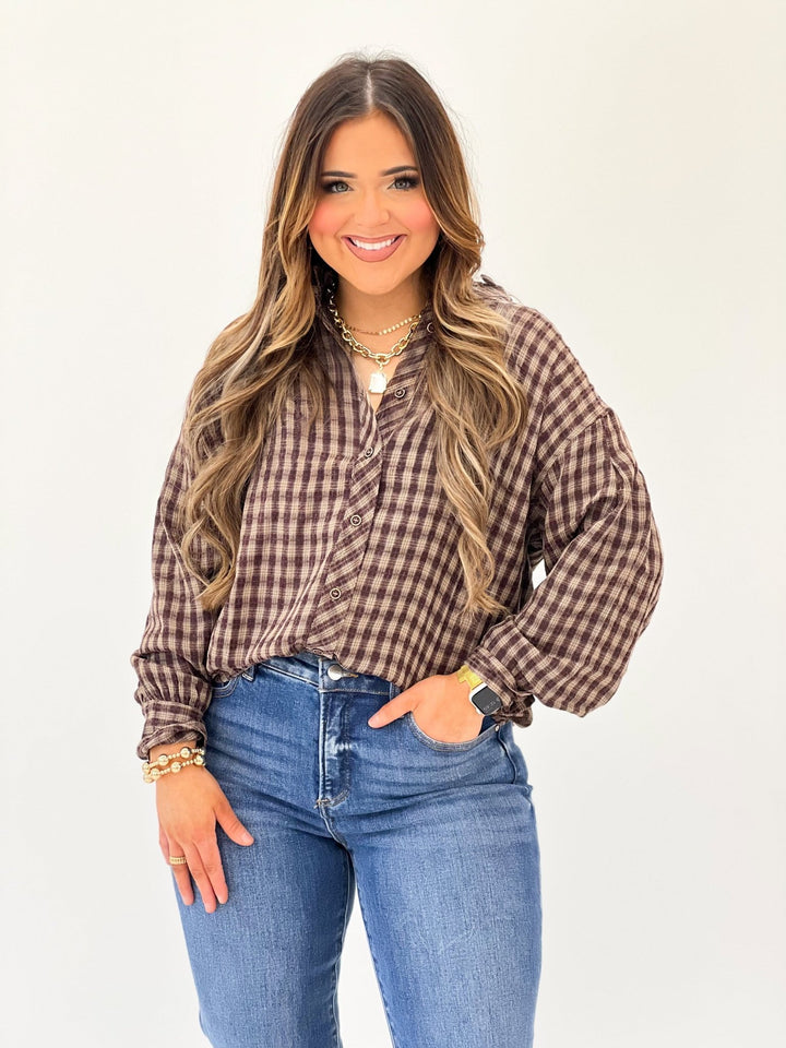 Brown plaid top with a ruffled neckline