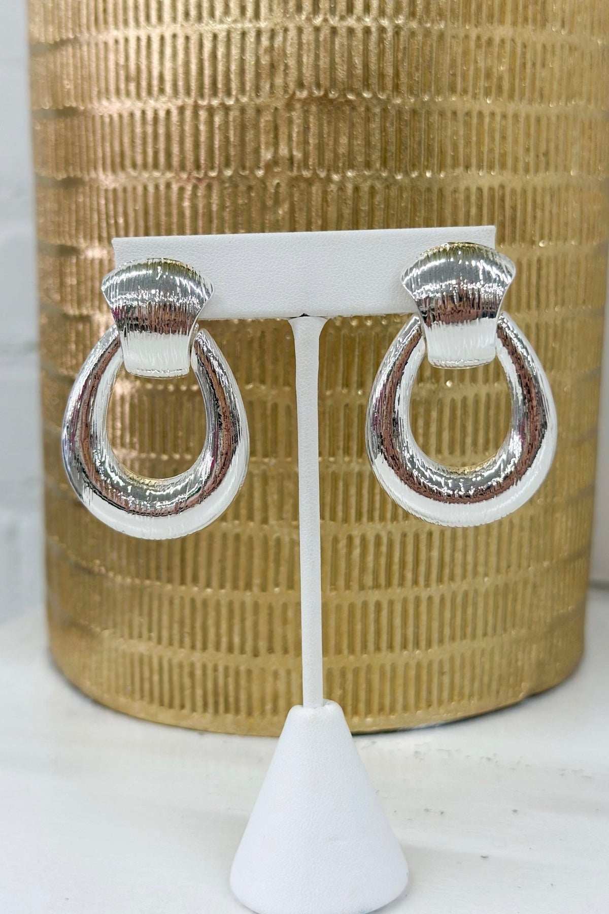 Door knocker earrings with a textured metal finish