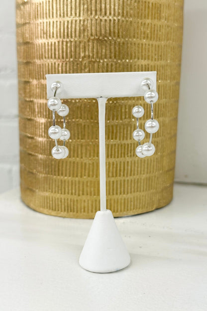 Open hoop earrings with a pearl accent