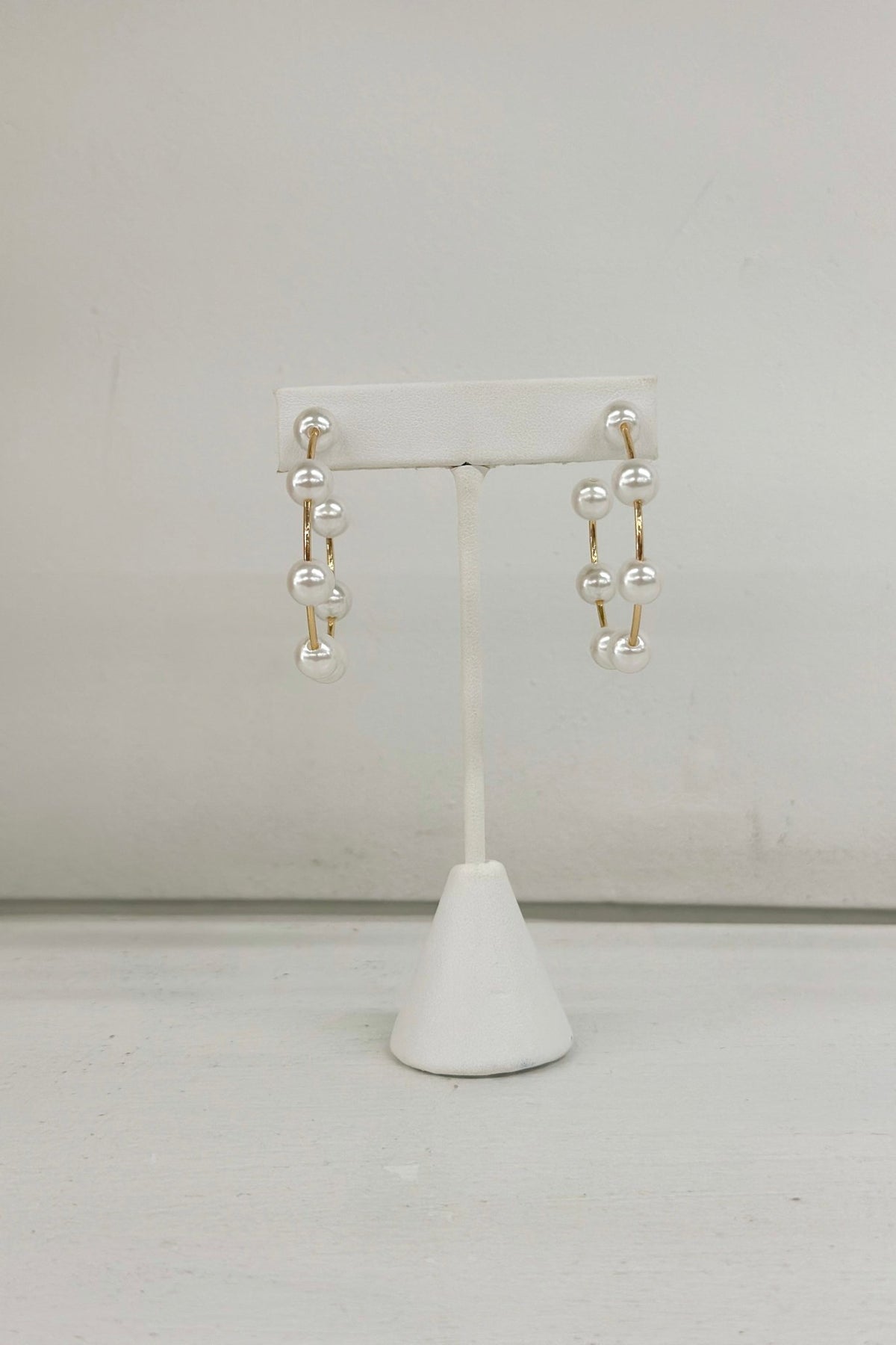 Metal open hoops finished with cream pearls