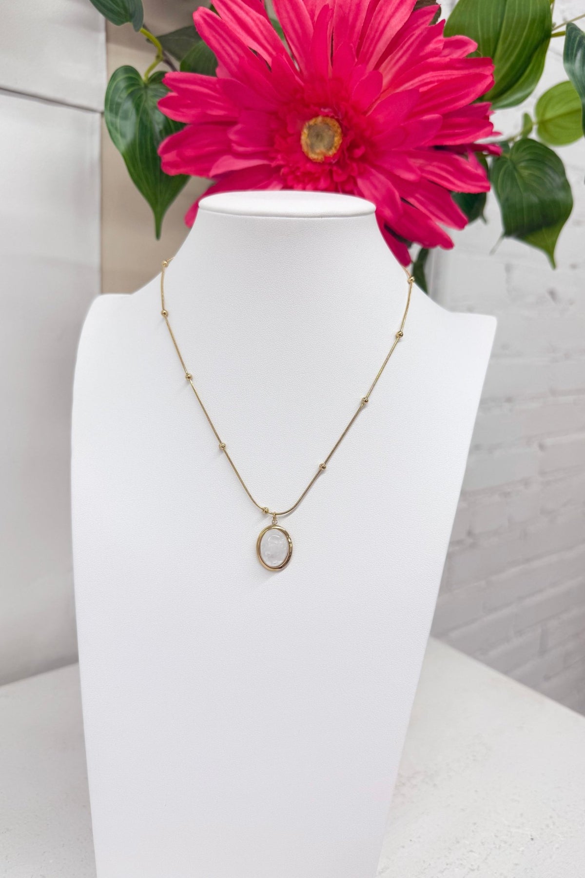 Opal stone set in gold on a chain necklace