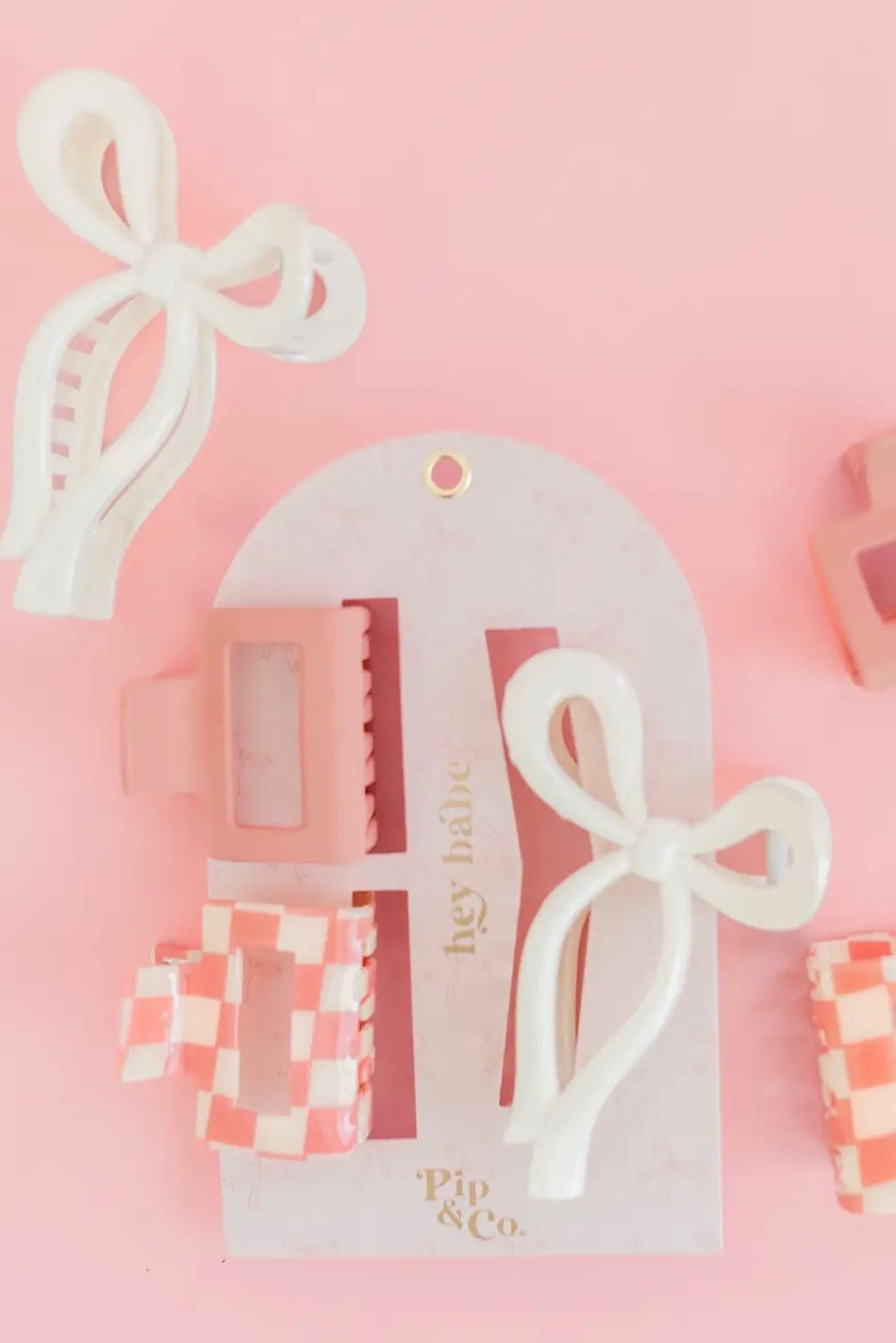 Set of pink claw clips with checker and bow designs
