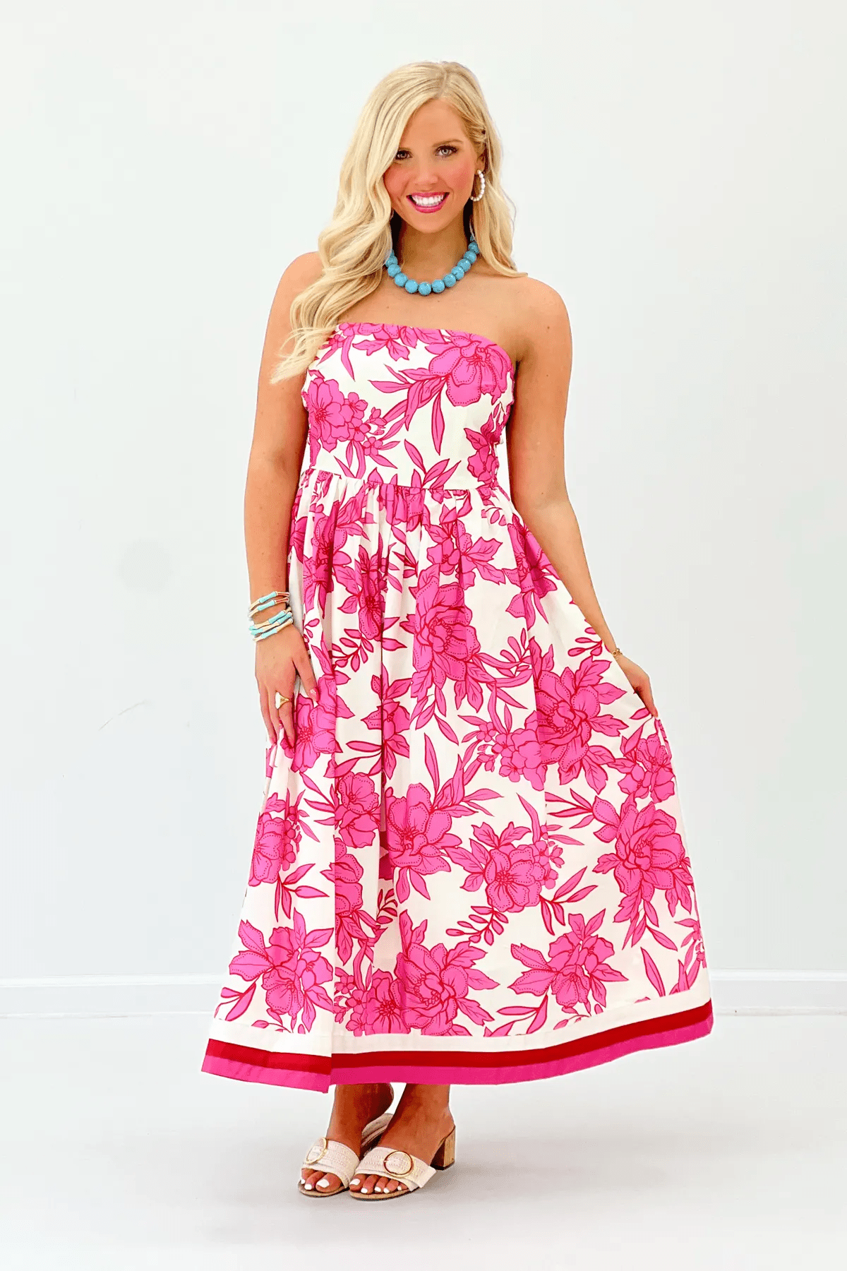 Pink floral strapless midi dress with a structured bodice