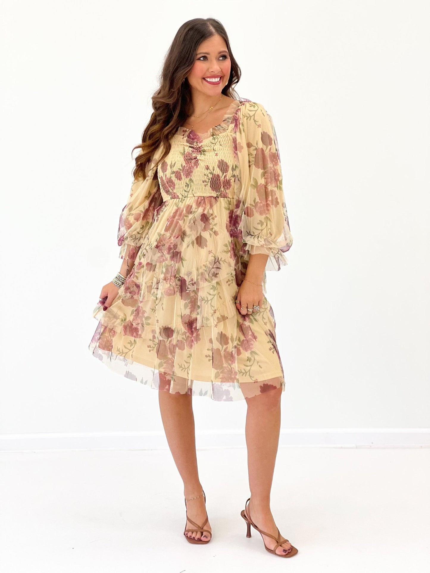 Floral pattern detail on a cream long sleeve dress
