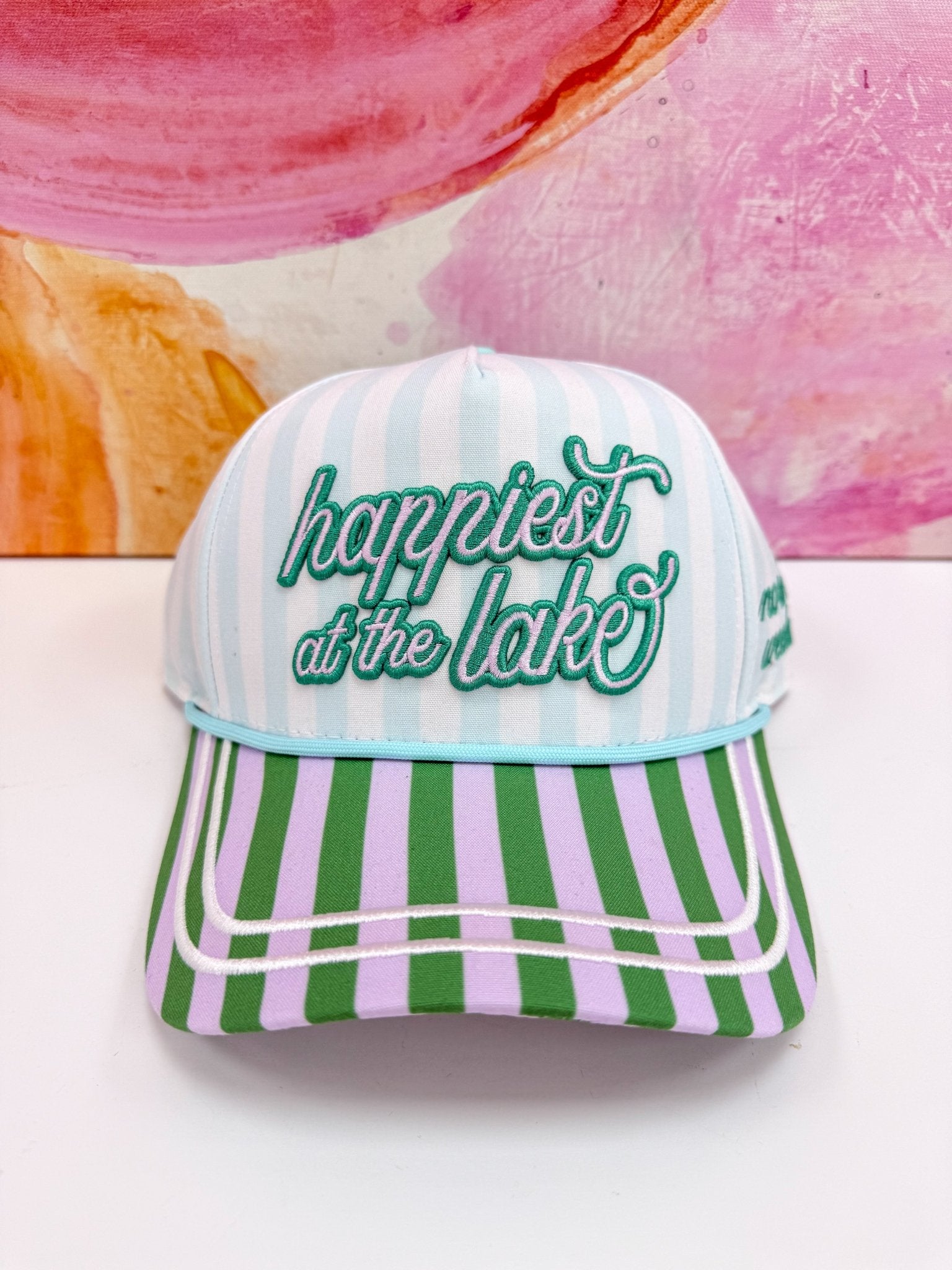 Happiest at the Lake lettering on a multicolour cap