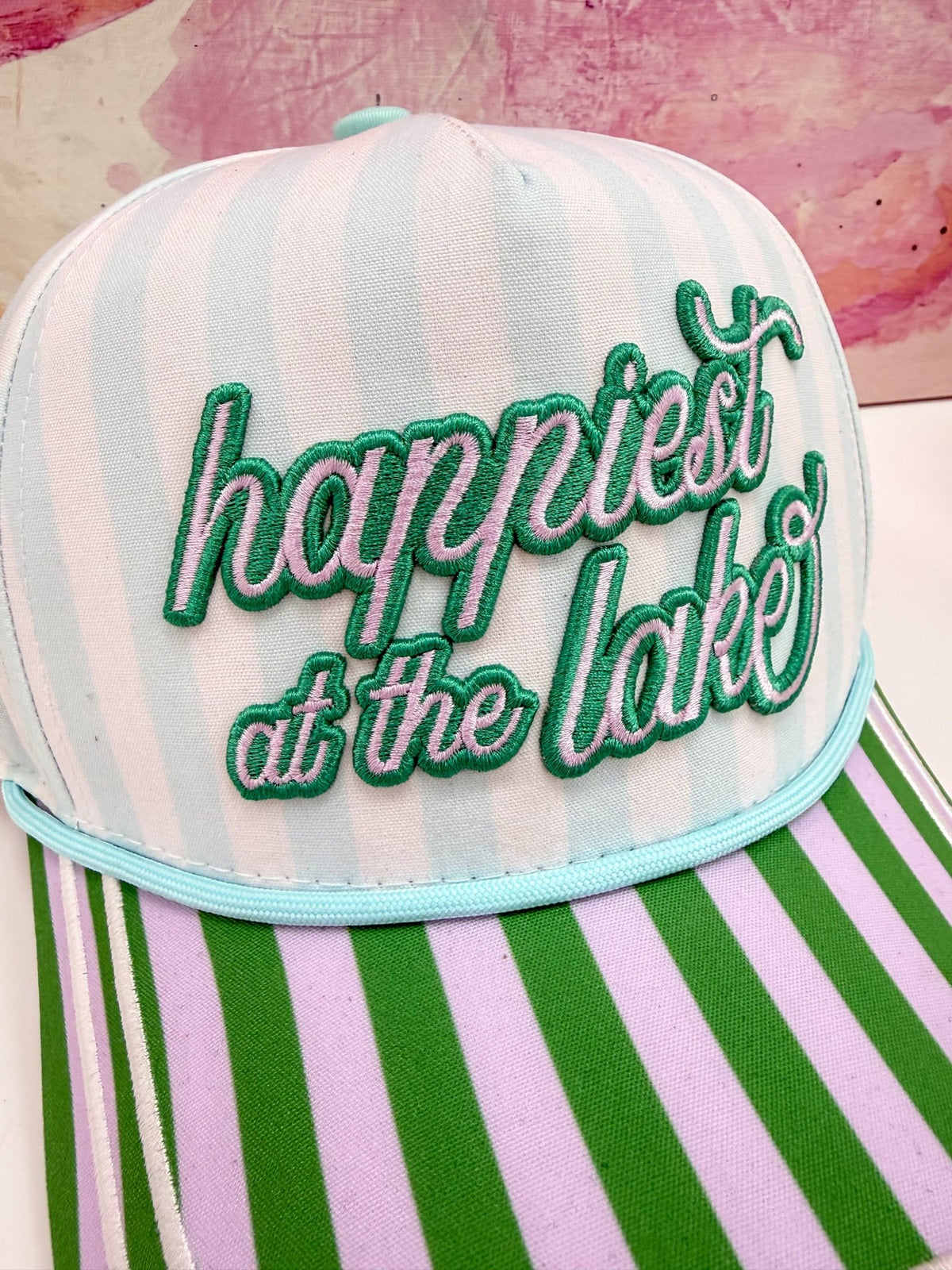 Lake-themed multicolour cap with Happiest at the Lake text on the front