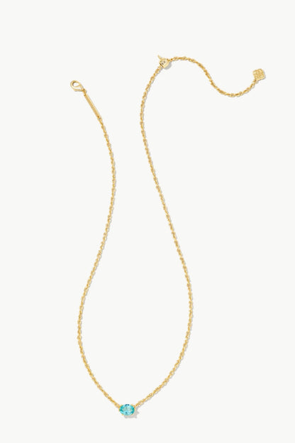 Gold pendant necklace with round aqua crystal at center, delicate chain