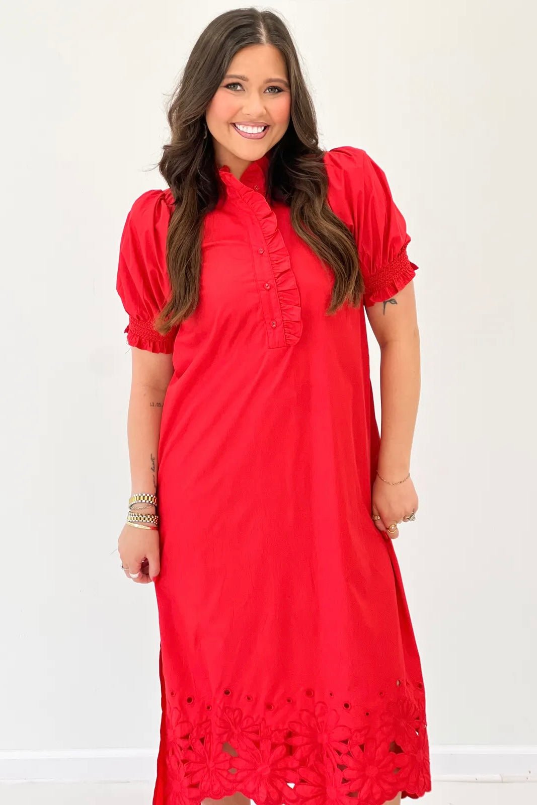 Scalloped hem and button front on a red puff sleeve dress