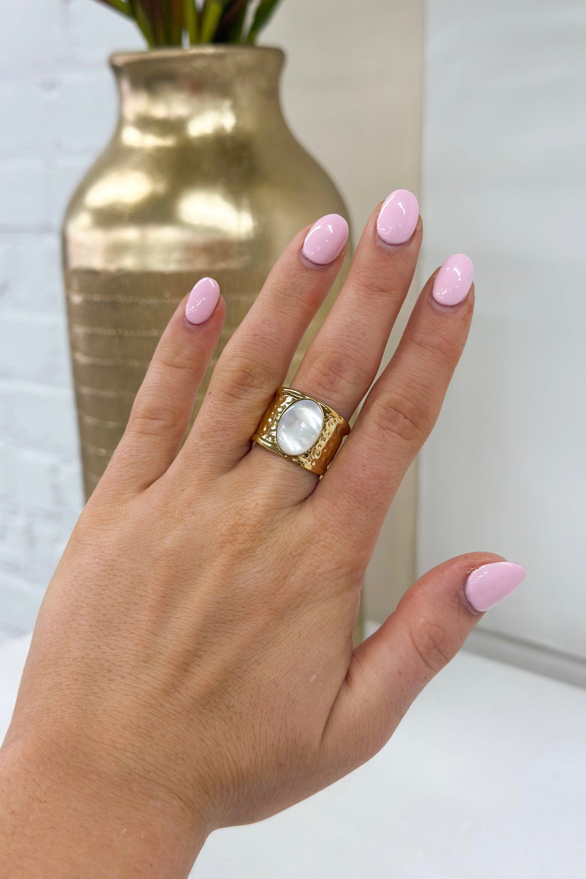 Gold opal band ring with square bezel and white iridescent stone