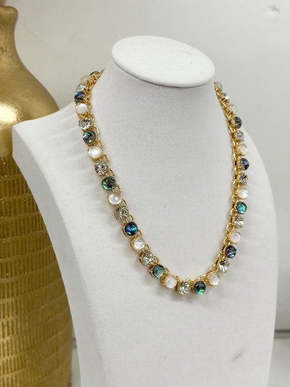 Round multicolor stones set along a gold-tone chain