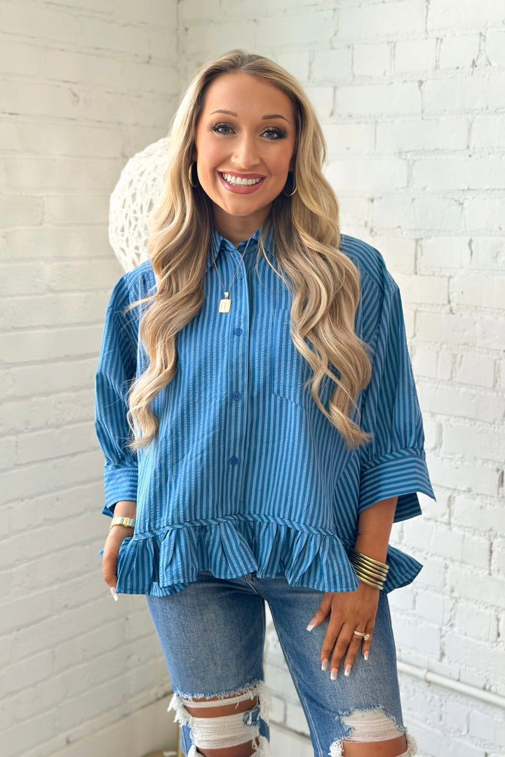 Button down top with a ruffled hem