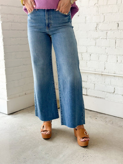 Wide leg denim with a raw scissor cut opening