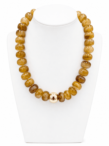 Gold accented bead necklace in earthy tones