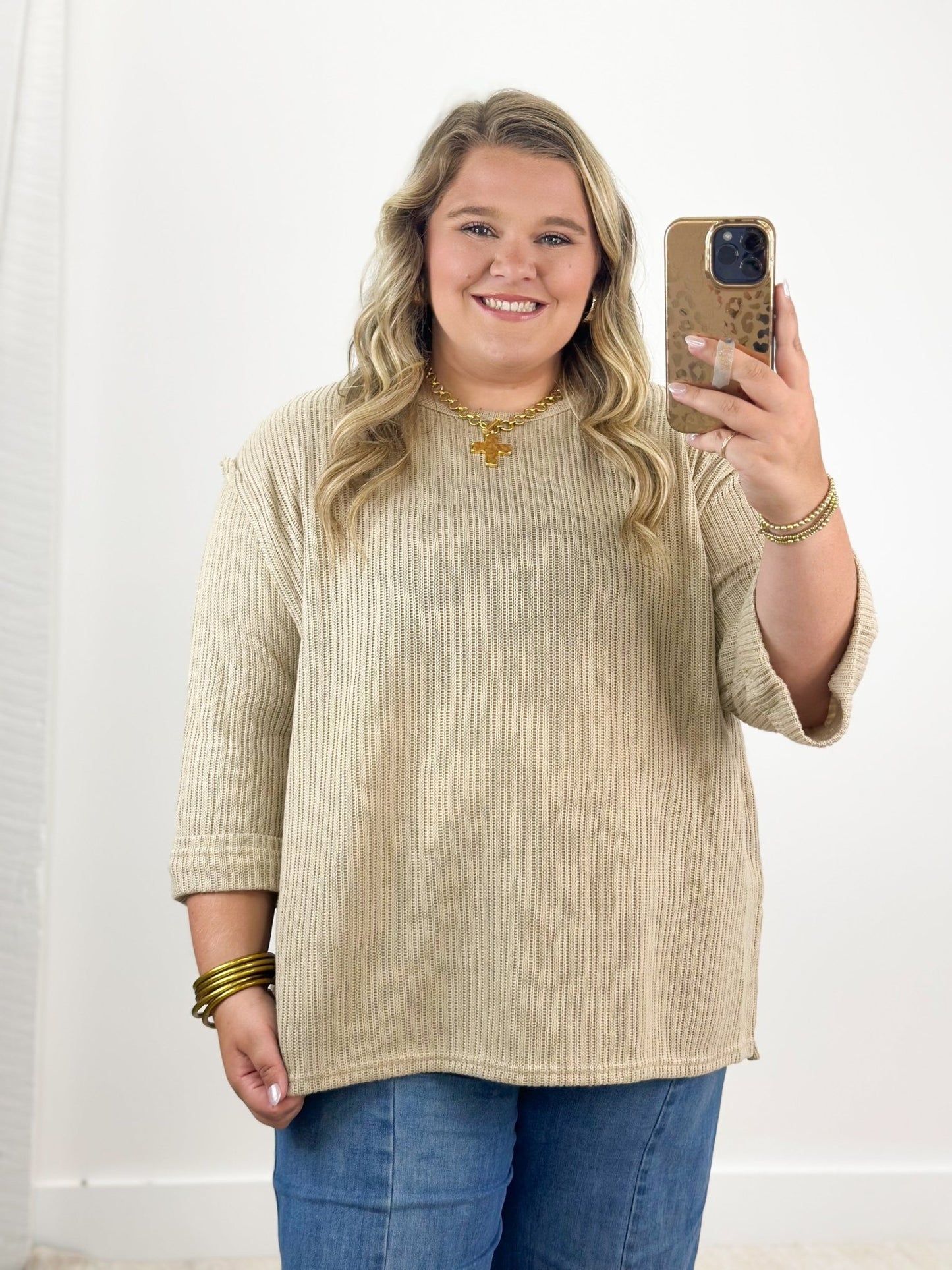Taupe knit top with 3/4 folded sleeves and round neckline, ribbed texture