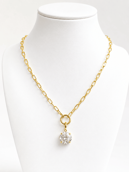 Faceted stone drop suspended from a gold chain
