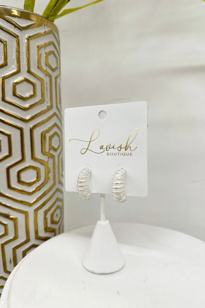 Silver 10mm thick metal hoops with a textured surface