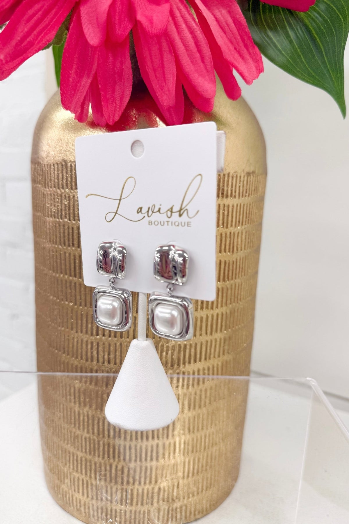 Silver-tone earrings with a pearl accent