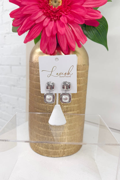 Pearl earrings in a polished silver setting