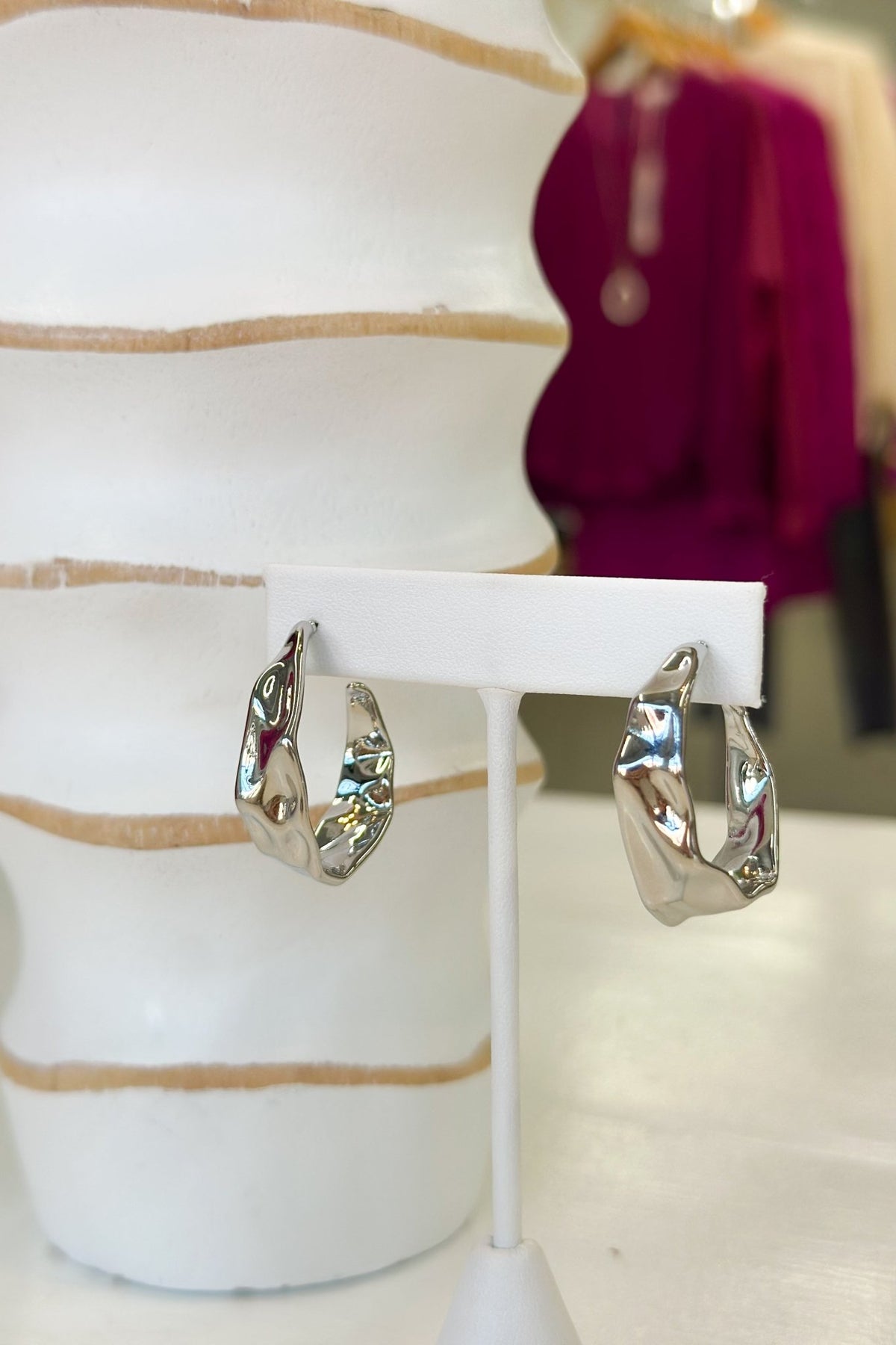 Silver hoop earrings with a hammered texture