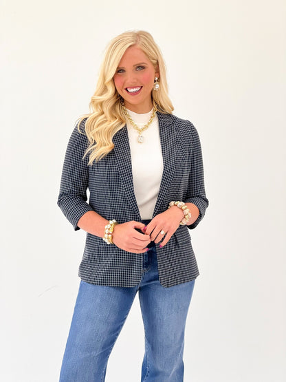 Navy checked grid print blazer with a button front and hip-length cut
