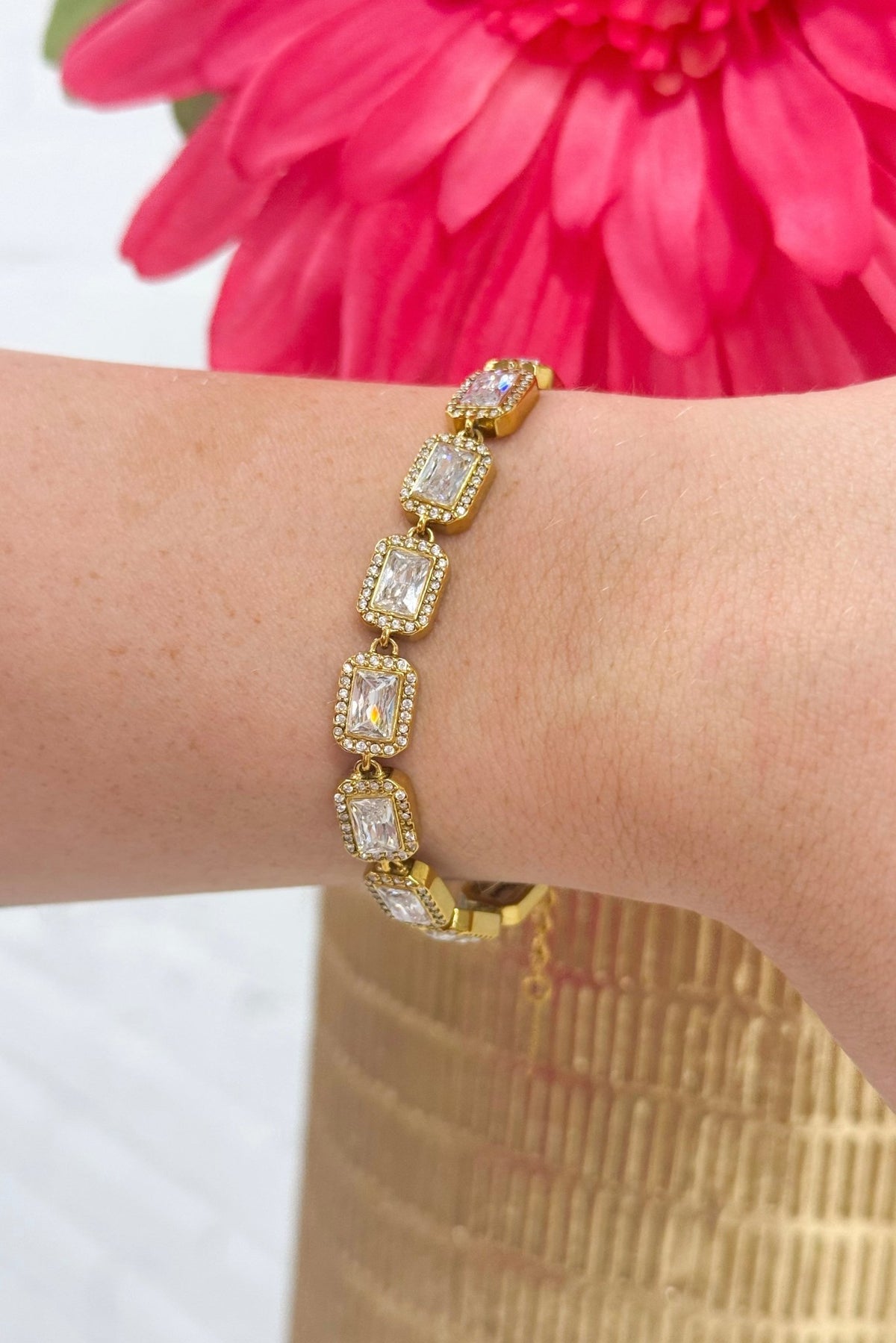 Gold bracelet with square set clear stones