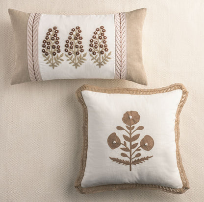 Ribbon-trimmed cream throw pillow with floral embroidery