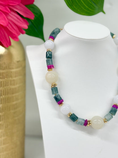 Round stone beads strung into a white multi necklace