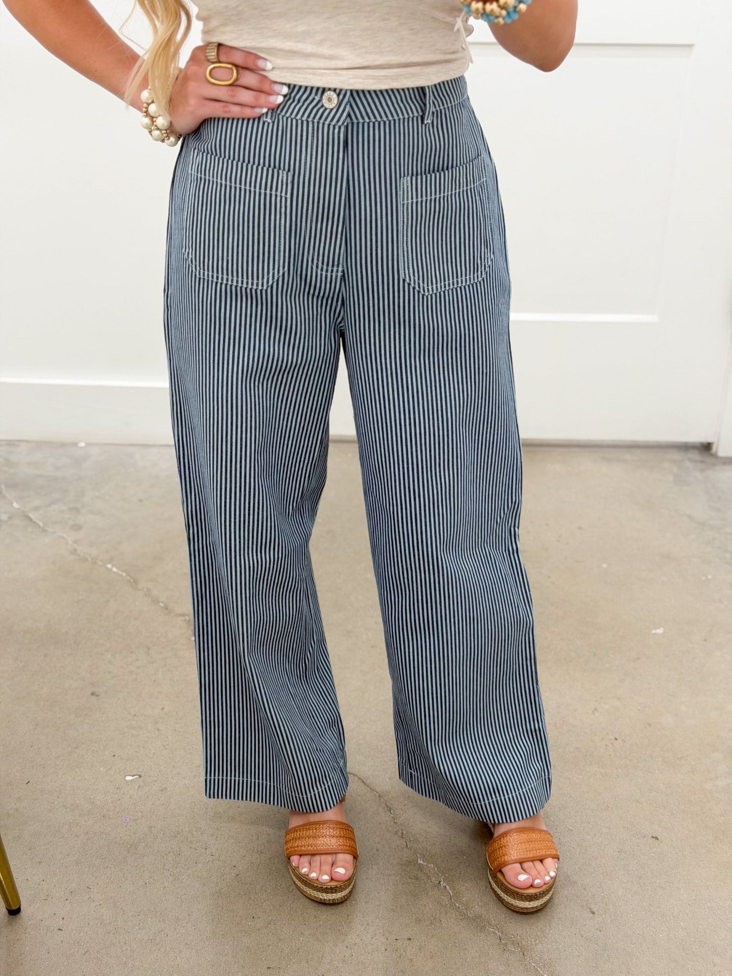 Striped navy pants with a relaxed leg and front pockets
