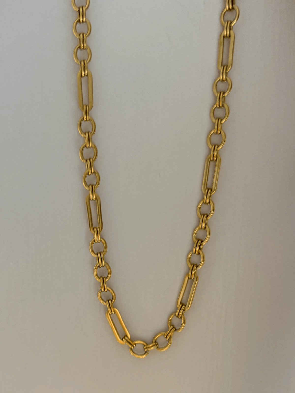 Gold chain necklace with a hanging pendant