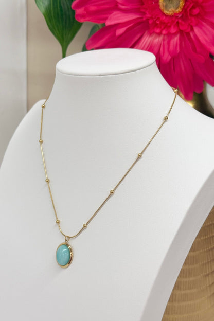 Turquoise pendant necklace with a gold bezel