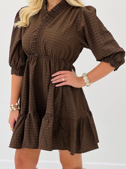Brown ruffled dress with elbow-length sleeves