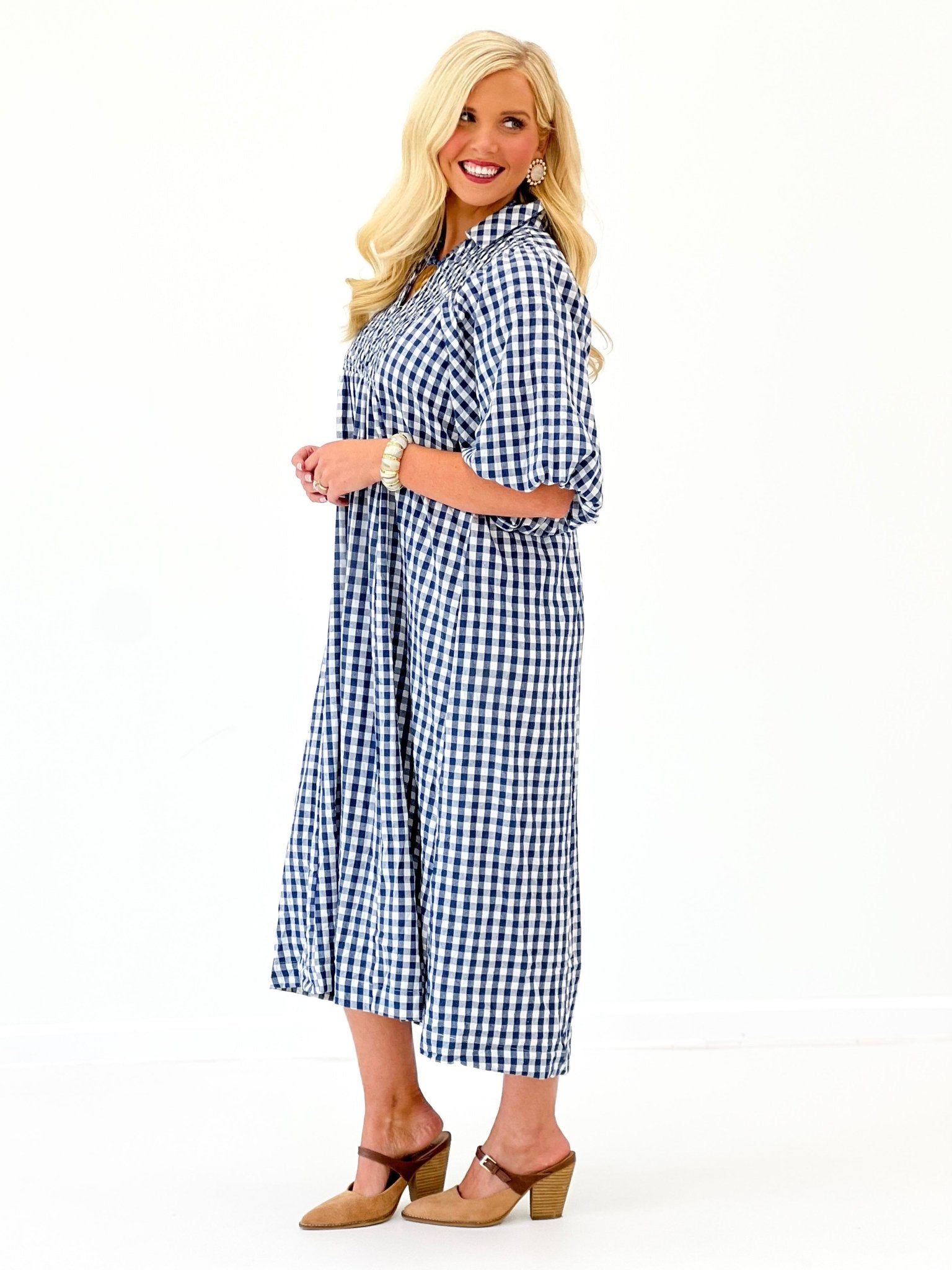 Denim blue plaid smocked midi dress with short sleeves and button-front, side view