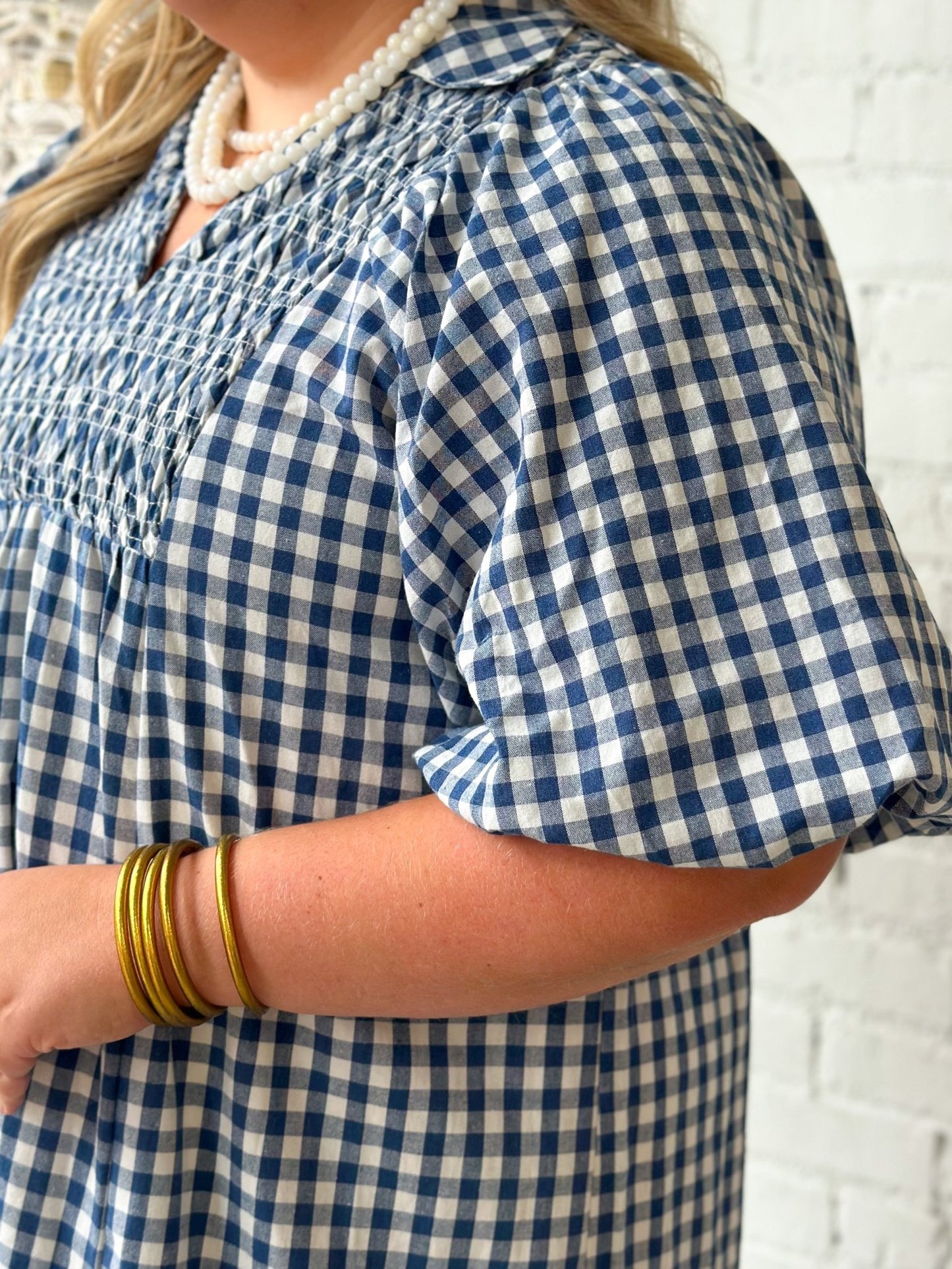 Plaid dress with smocking across the shoulders
