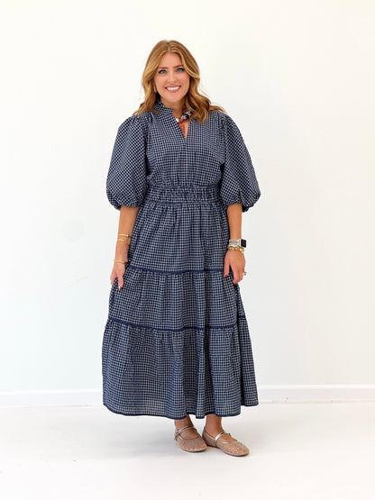 Plaid pattern on a navy tiered midi dress