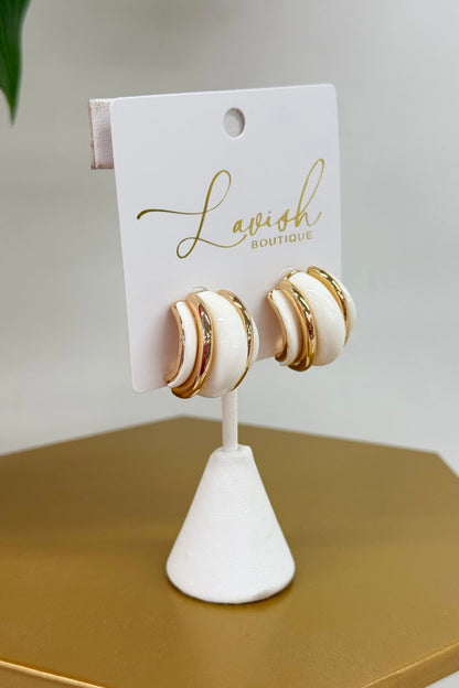 Wide half hoops in white and gold tones