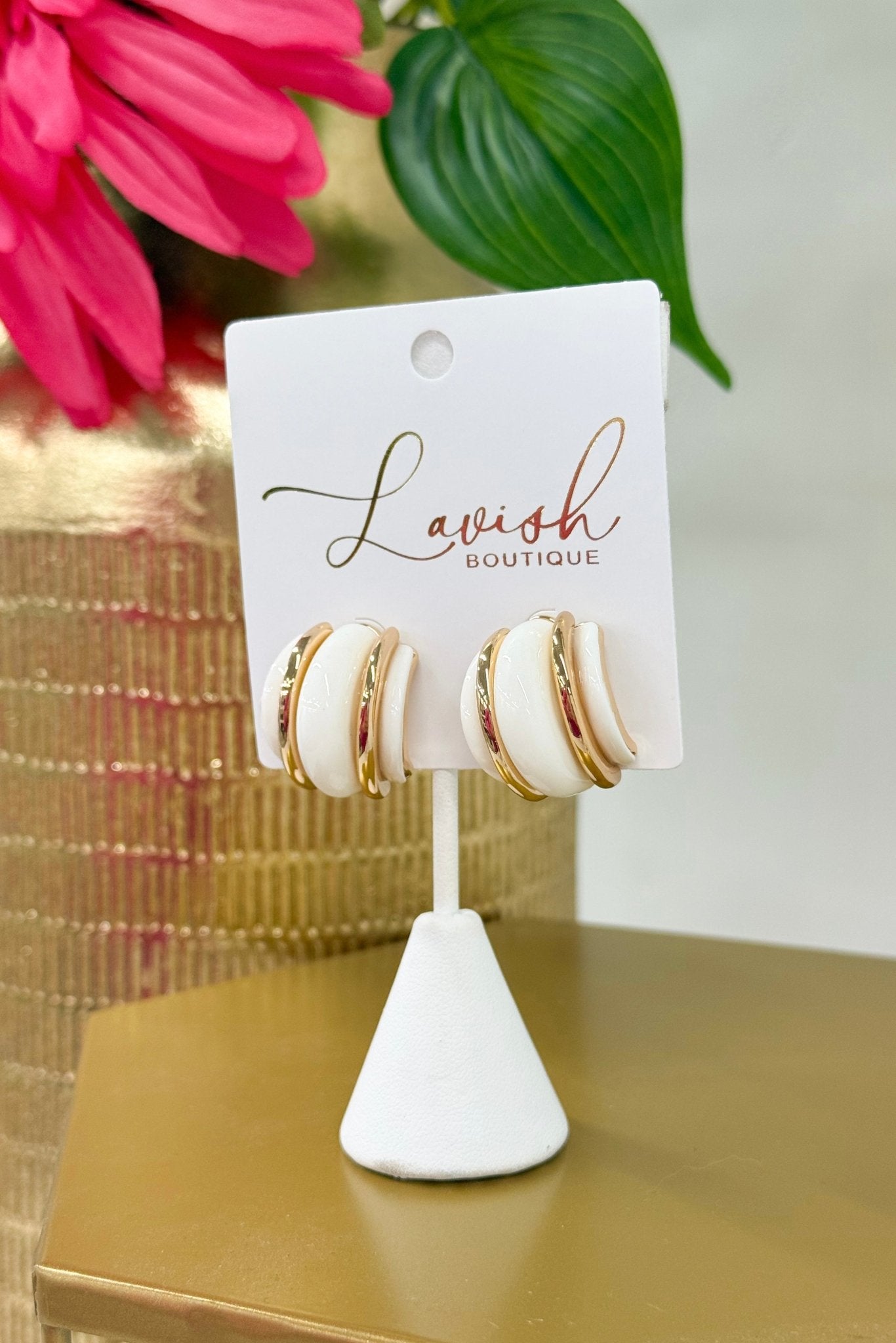 Half hoop earrings layering white over gold