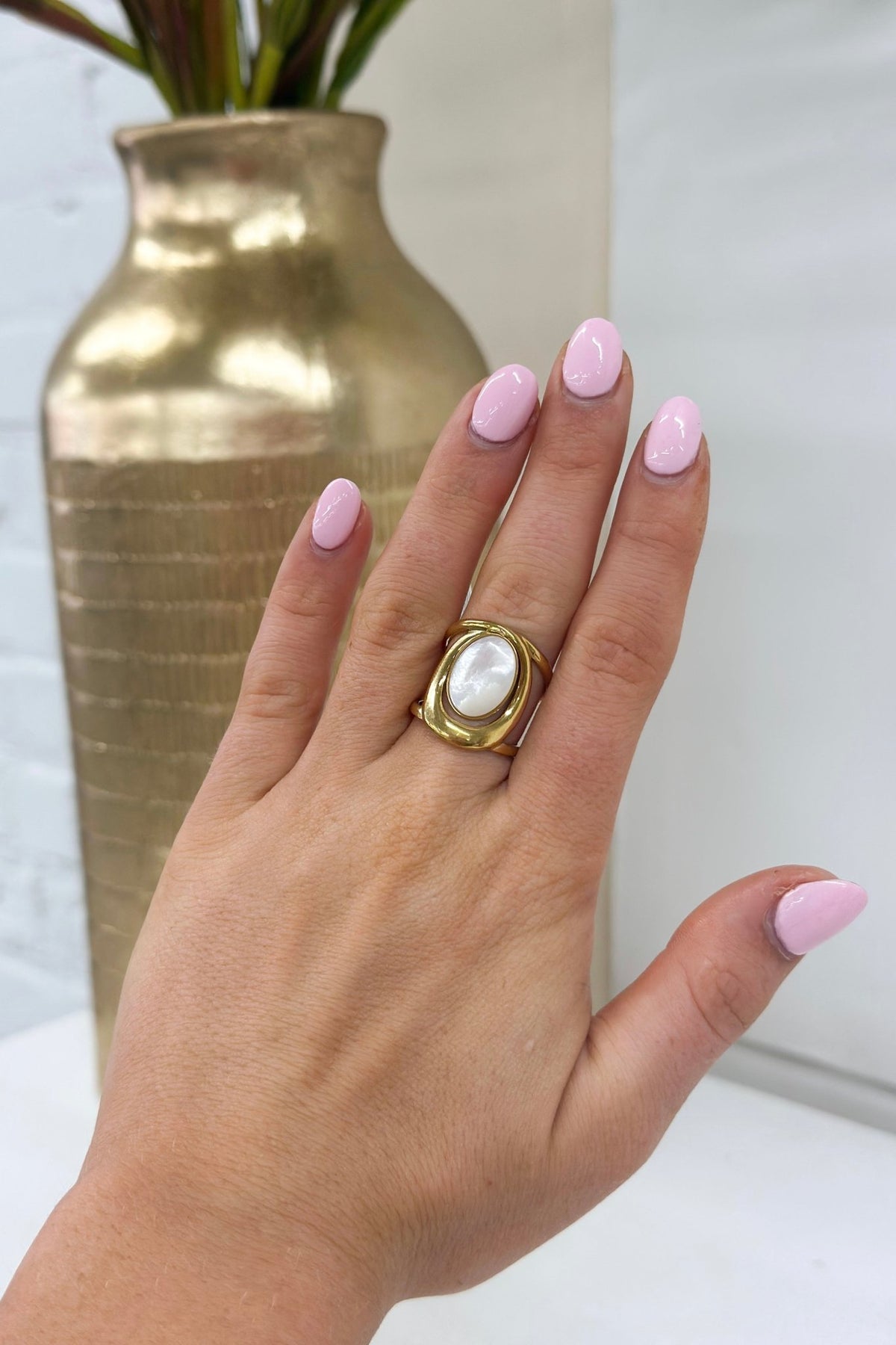 White stone ring in a gold-tone setting