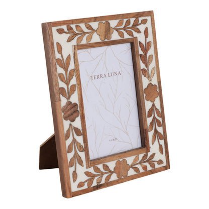 White and brown wooden picture frame with a sculpted petal surround