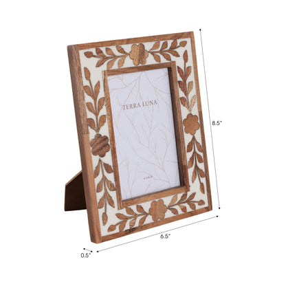 White and brown wooden frame with petal shapes around the opening