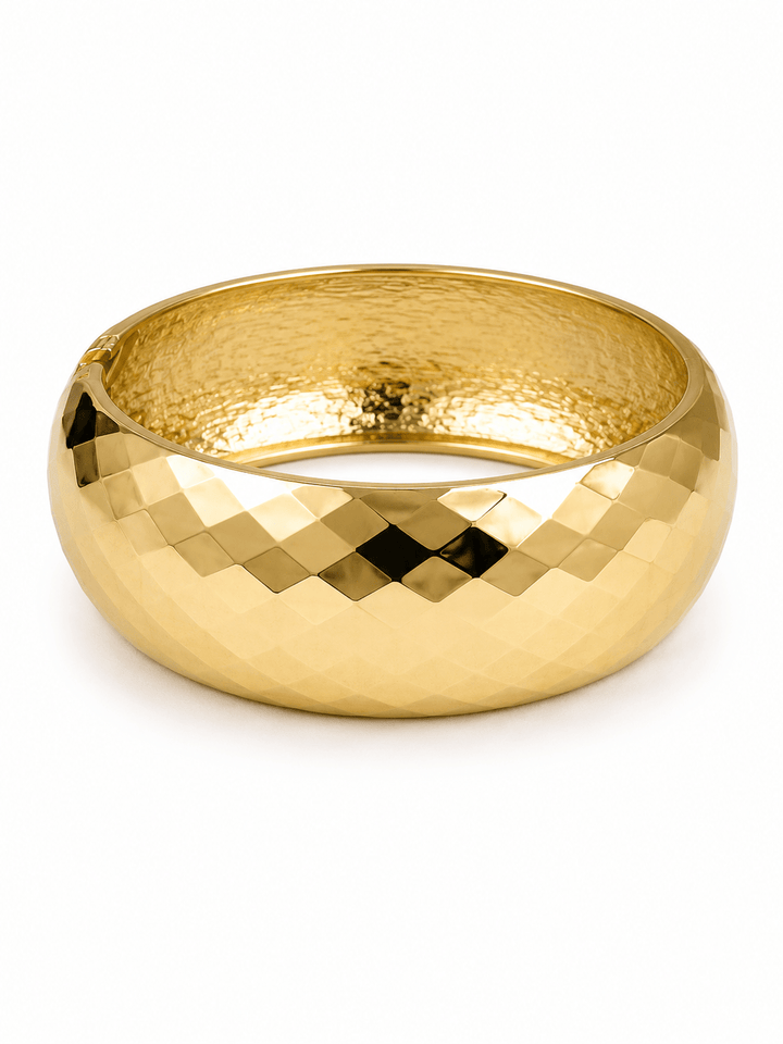 Gold wide bangle with a faceted surface