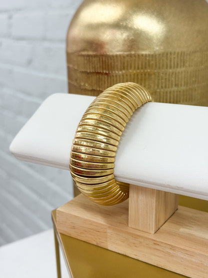 Wide vintage gold cuff with a smooth surface