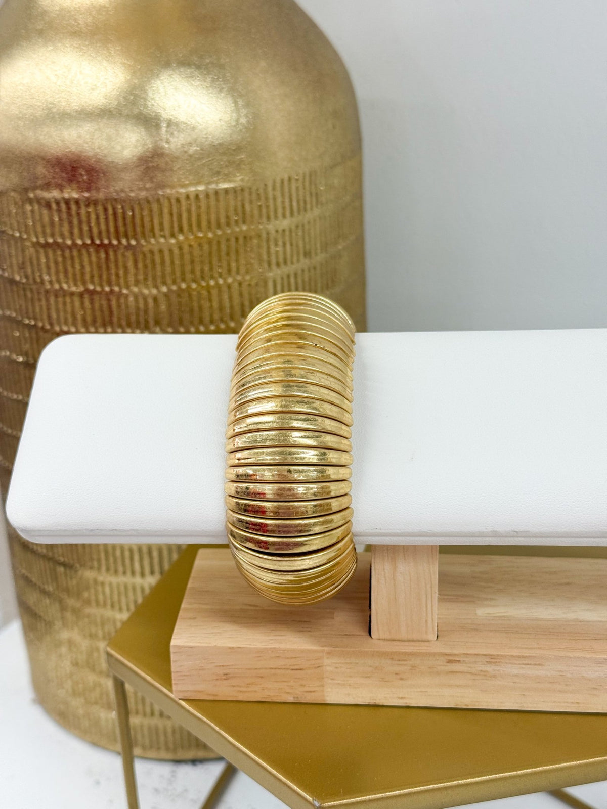 Wide metal bracelet in a warm vintage gold tone