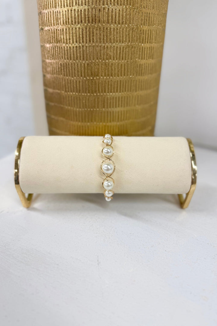 Cream pearl bracelet on a wired gold band
