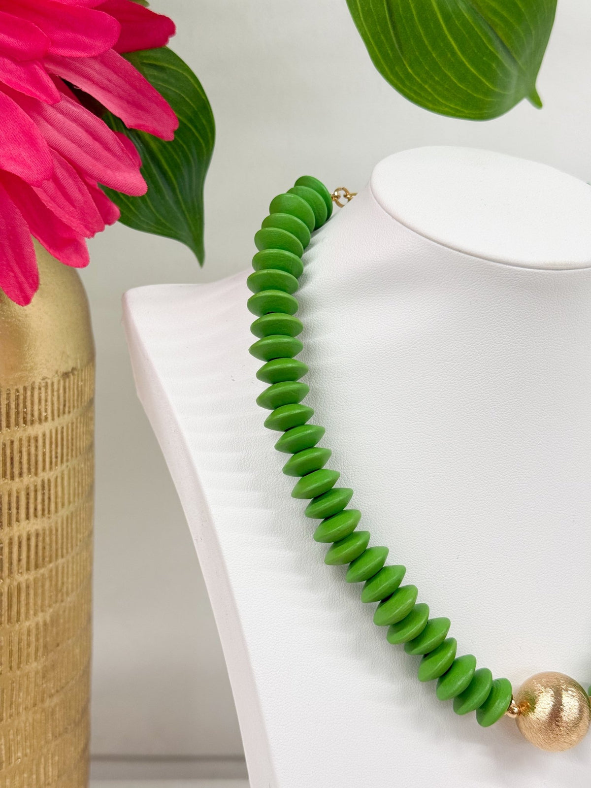 Green wooden beads strung with gold-tone accents