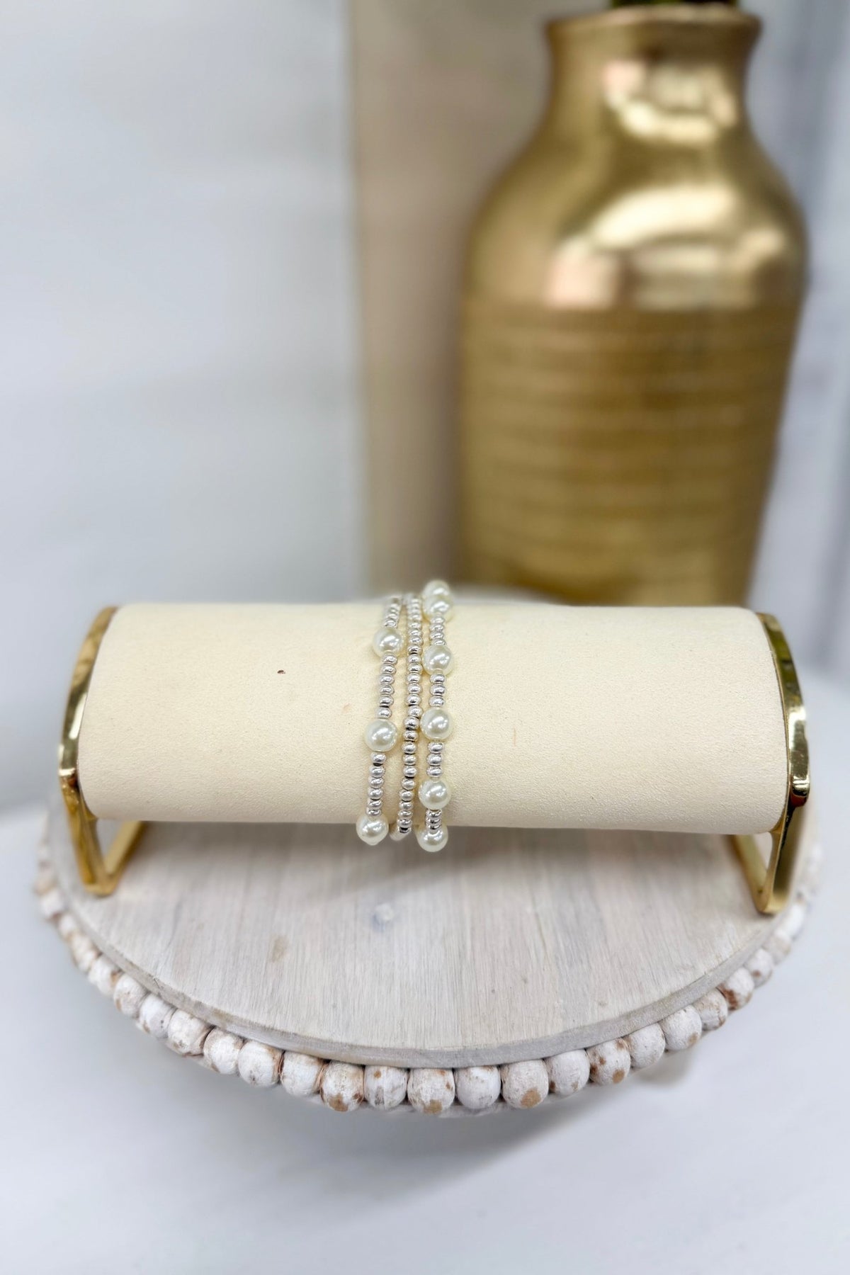Worn silver three-row bracelet with cream pearl stations