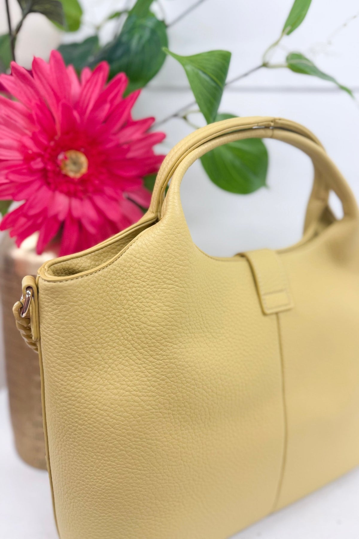 Yellow tote bag with metal chain accents