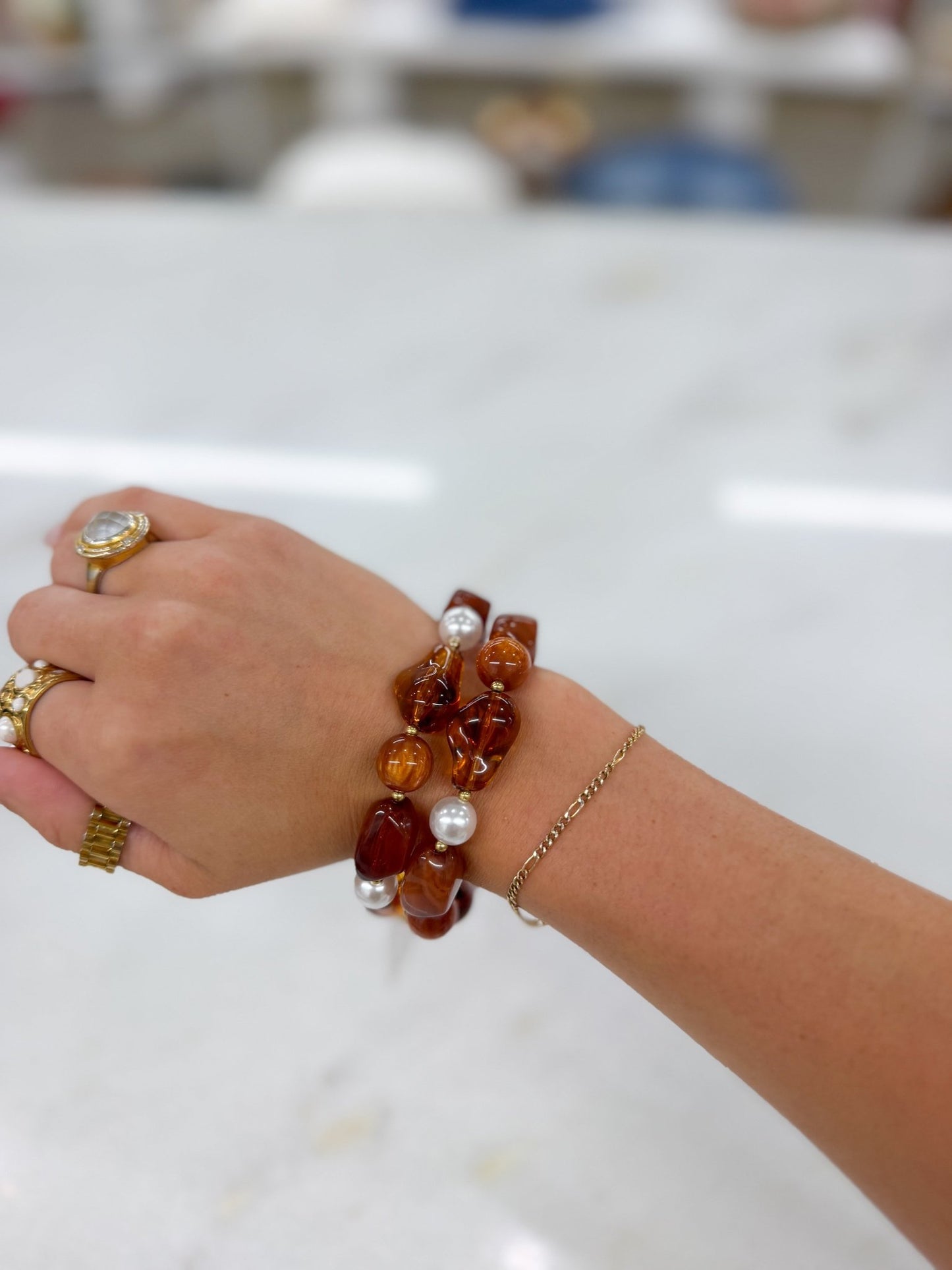 Tortoise toned beads with gold accents on a bracelet