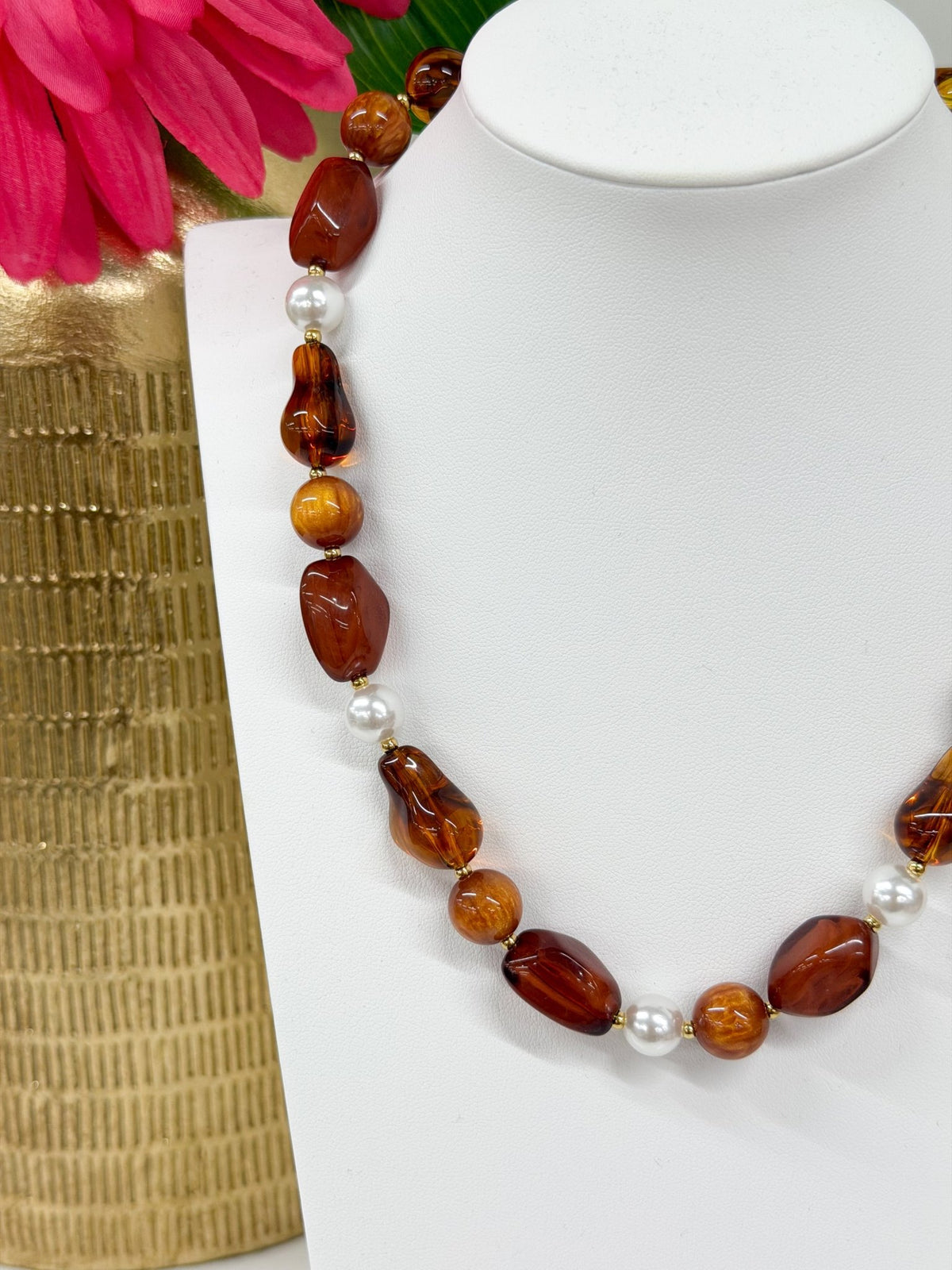 Tortoise toned beads strung with gold-tone accents